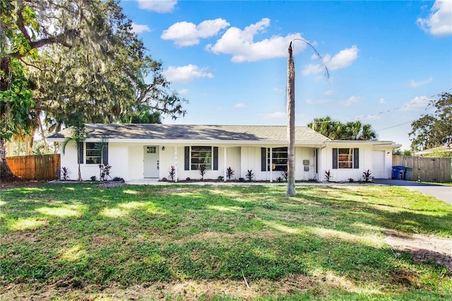 ranch-style house with a front lawn, a garage, and a porch