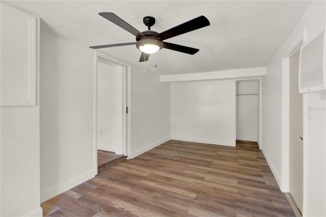 interior space with hardwood / wood-style floors and ceiling fan