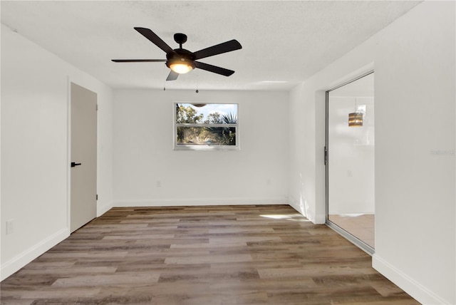 unfurnished room featuring light hardwood / wood-style flooring and ceiling fan