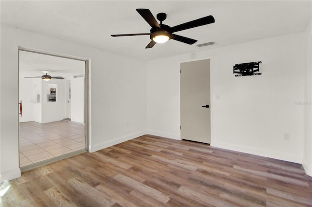 unfurnished room with ceiling fan and light hardwood / wood-style flooring