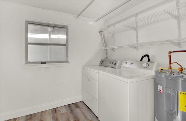 laundry room with water heater, light wood-type flooring, and independent washer and dryer