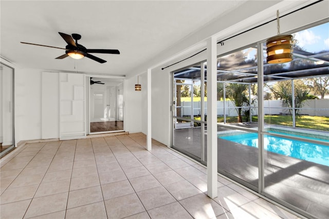 interior space with light tile patterned floors and ceiling fan