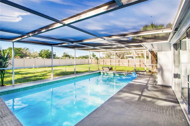 view of pool with a patio area, a lawn, and a lanai