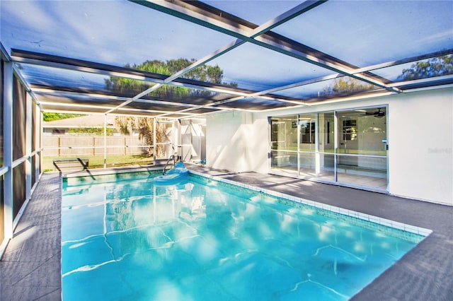 view of swimming pool with a lanai