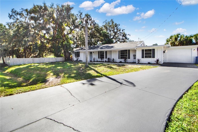 ranch-style house with a garage and a front yard