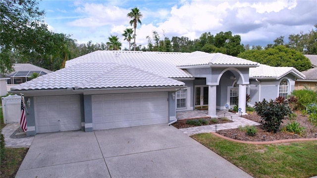 mediterranean / spanish home featuring french doors and a garage