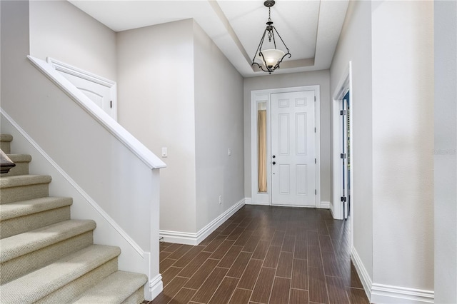 entryway with dark hardwood / wood-style flooring