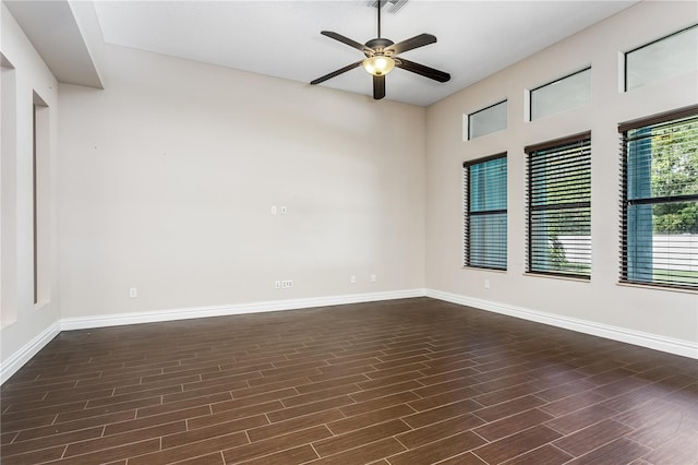 spare room featuring dark hardwood / wood-style flooring and ceiling fan