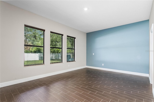 spare room featuring dark wood-type flooring