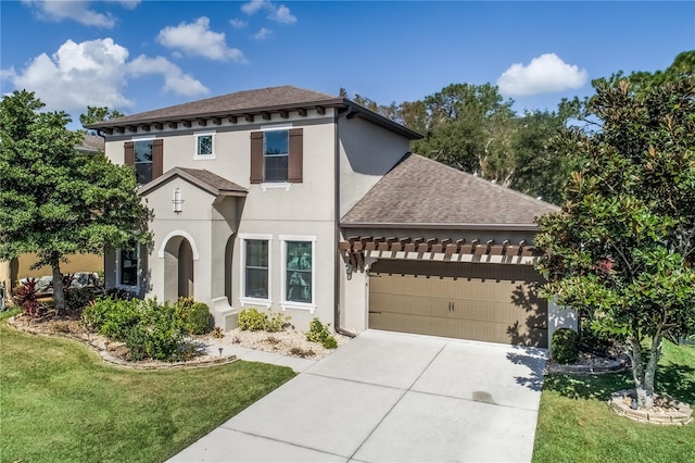 mediterranean / spanish home featuring a front yard and a garage