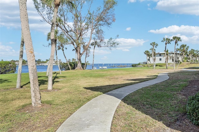 view of property's community featuring a water view and a lawn