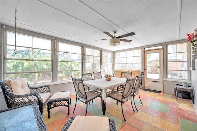 sunroom / solarium featuring ceiling fan