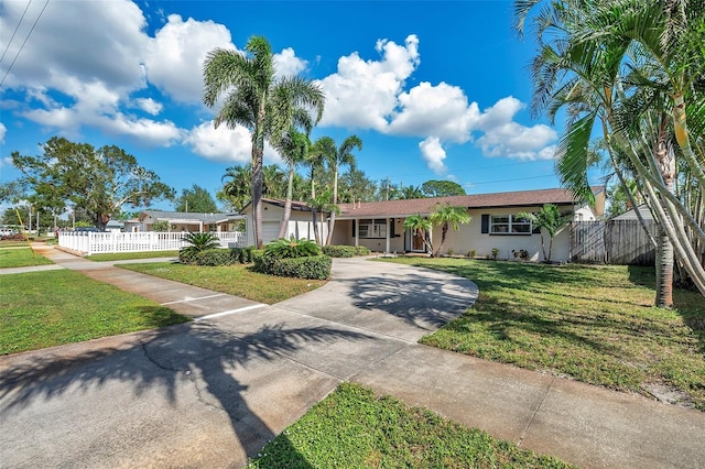 single story home with a garage and a front lawn