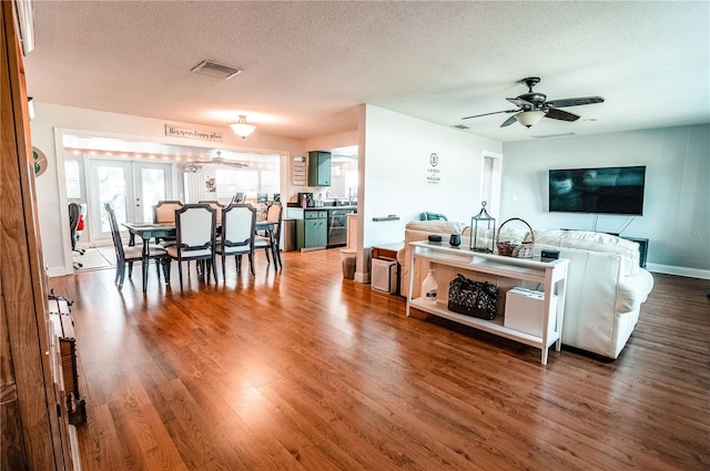 kitchen with visible vents, french doors, a ceiling fan, and wood finished floors