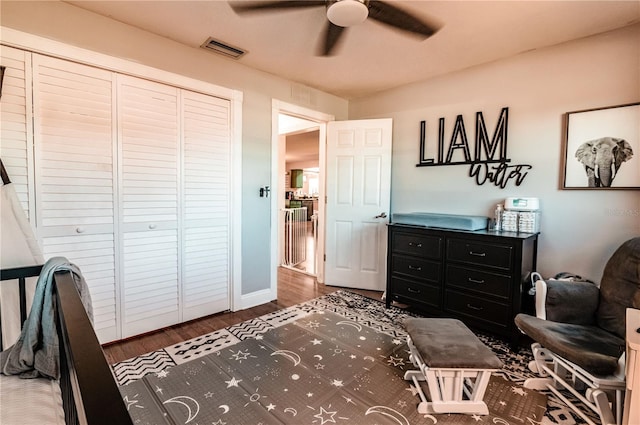 bedroom with ceiling fan, a closet, and dark hardwood / wood-style floors