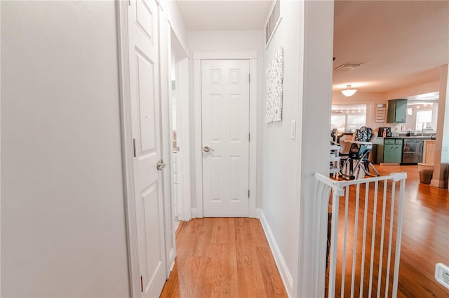 hall featuring sink and light hardwood / wood-style flooring