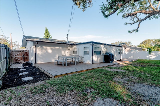 back of property with a wooden deck