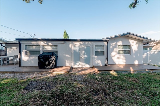 rear view of property featuring a deck