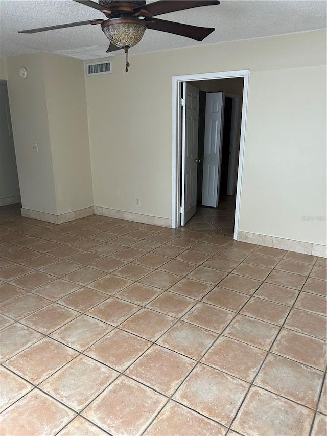 spare room with a textured ceiling and ceiling fan