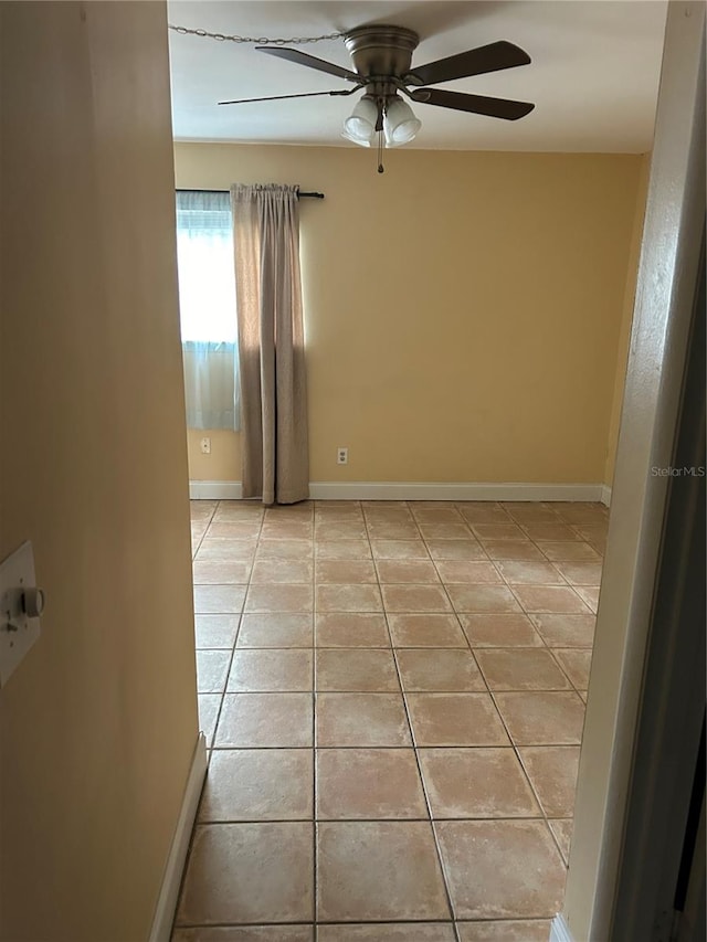 tiled empty room with ceiling fan