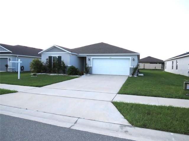 ranch-style house with a garage and a front yard