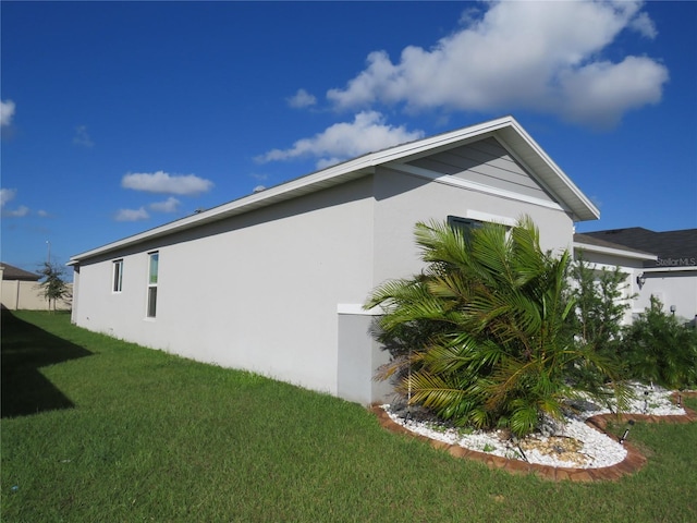 view of property exterior featuring a lawn