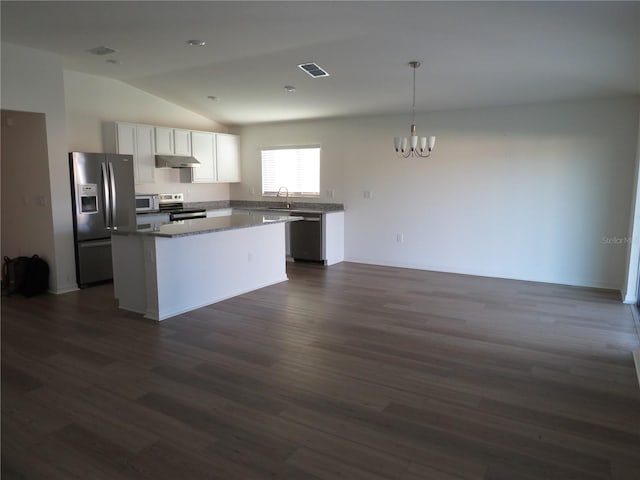 kitchen with lofted ceiling, a kitchen island, dark hardwood / wood-style flooring, white cabinetry, and stainless steel appliances