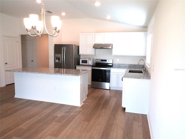 kitchen featuring sink, stainless steel appliances, hardwood / wood-style floors, vaulted ceiling, and white cabinets