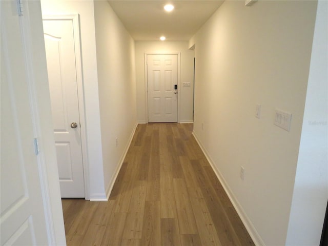 corridor with light hardwood / wood-style flooring