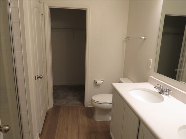 bathroom featuring hardwood / wood-style flooring, vanity, and toilet