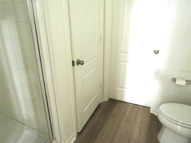 148 Summerlin Loop, Haines City, FL 33844 - full bathroom featuring a shower stall, wood finished floors, and toilet