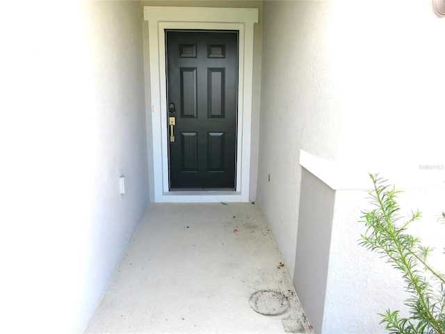 148 Summerlin Loop, Haines City, FL 33844 - property entrance featuring stucco siding