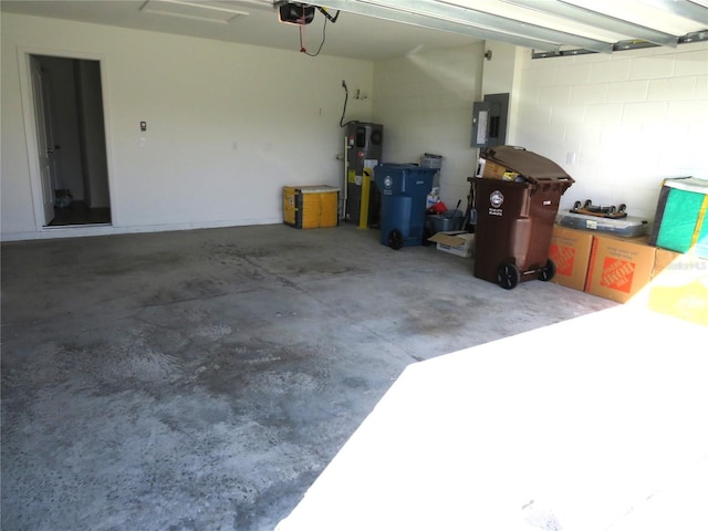 garage with hybrid water heater, electric panel, and a garage door opener