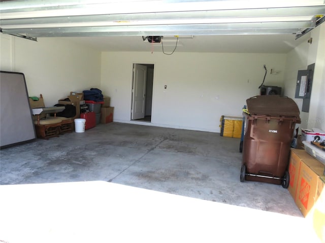 garage with electric panel and a garage door opener