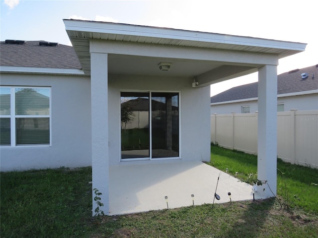 rear view of house featuring a patio area and a yard