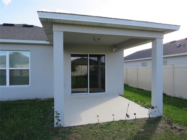 148 Summerlin Loop, Haines City, FL 33844 - rear view of property with a patio area, stucco siding, and a shingled roof