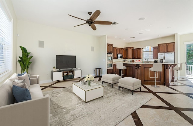 living room featuring sink and ceiling fan