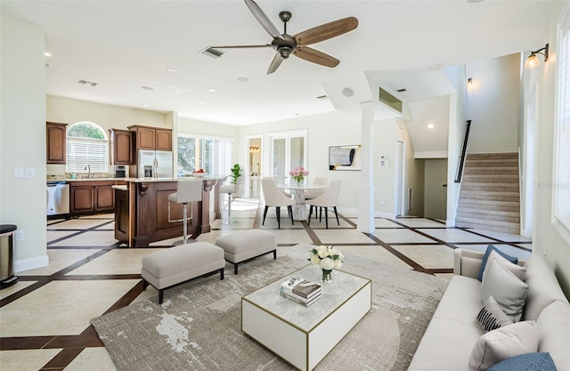 living room with sink and ceiling fan