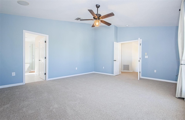 unfurnished bedroom with ceiling fan, lofted ceiling, light carpet, and ensuite bath