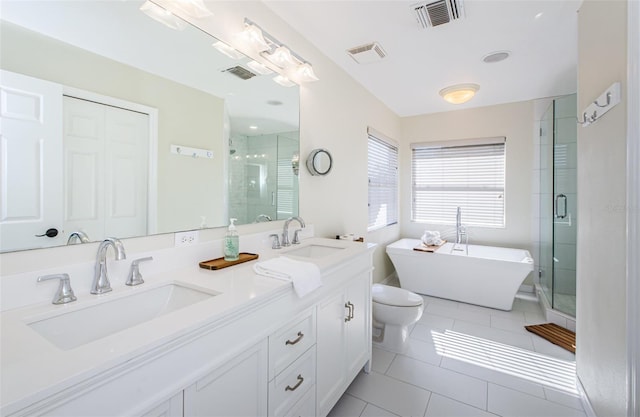 full bathroom featuring vanity, tile patterned floors, toilet, and separate shower and tub