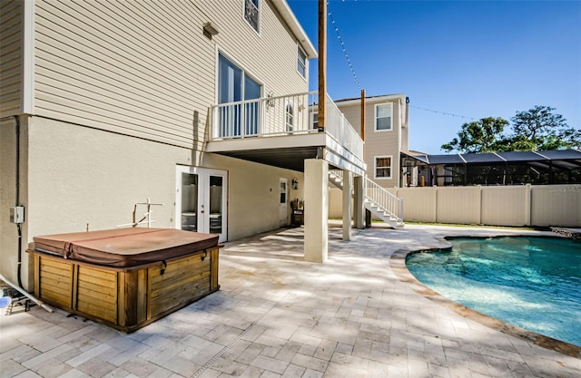 view of swimming pool with a patio area and a hot tub