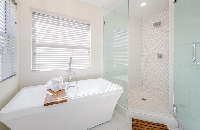 bathroom featuring plenty of natural light, tile patterned floors, and separate shower and tub