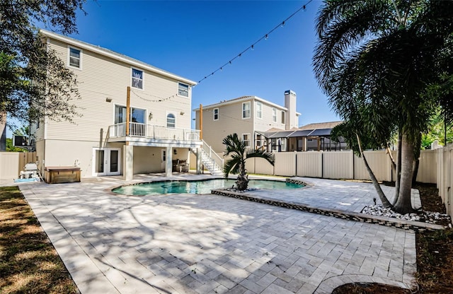 view of swimming pool with a patio area, a hot tub, and french doors