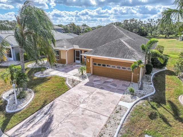 single story home featuring a garage and a front yard