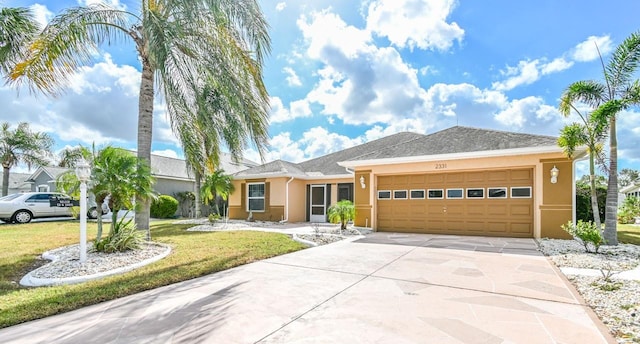 ranch-style house featuring a garage and a front yard