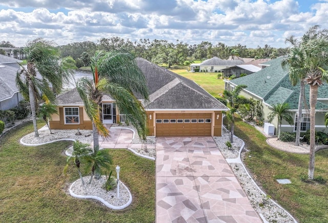 view of front of property featuring a front yard and a garage