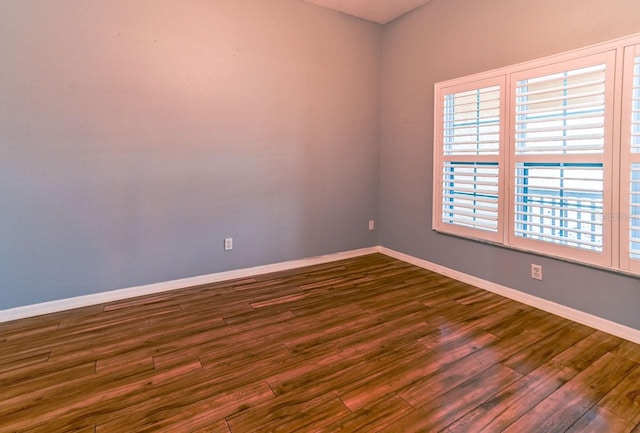 empty room with dark wood-type flooring