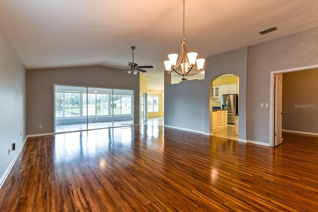 empty room with hardwood / wood-style floors, ceiling fan with notable chandelier, and lofted ceiling