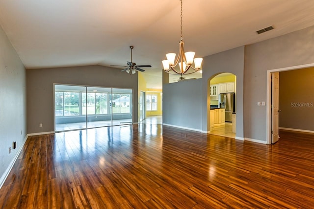 empty room featuring hardwood / wood-style floors, ceiling fan with notable chandelier, and lofted ceiling