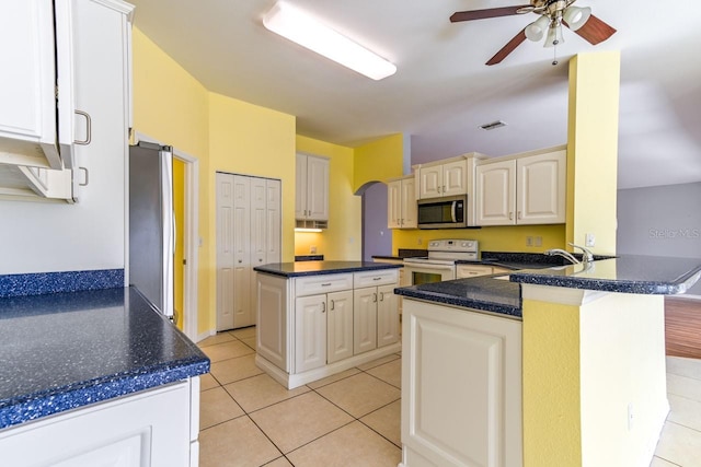 kitchen featuring kitchen peninsula, appliances with stainless steel finishes, ceiling fan, sink, and light tile patterned flooring